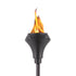 Black metal TIKI® torch with decorative cutouts, shown lit with a bright flame against a white background.