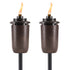Pair of bronze TIKI torches with visible flames, designed for outdoor lighting and ambiance.