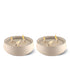 Two beige TIKI® brand outdoor candles, each with three lit wicks in round bowls, designed for patio use.