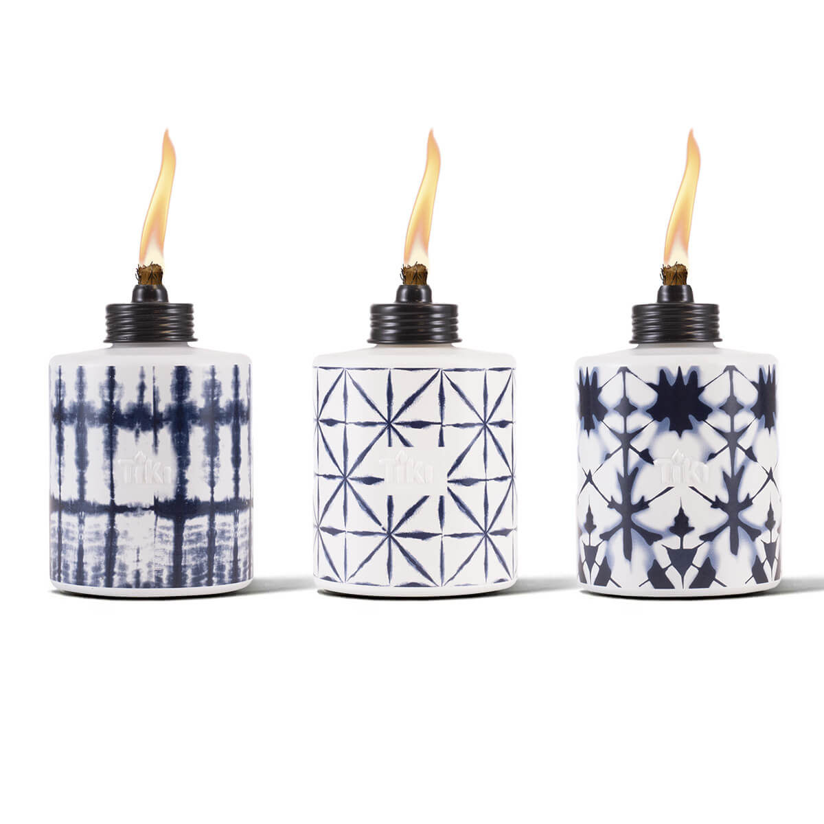 Three ceramic TIKI torches with blue and white geometric patterns, each lit with a visible flame, on a white background.