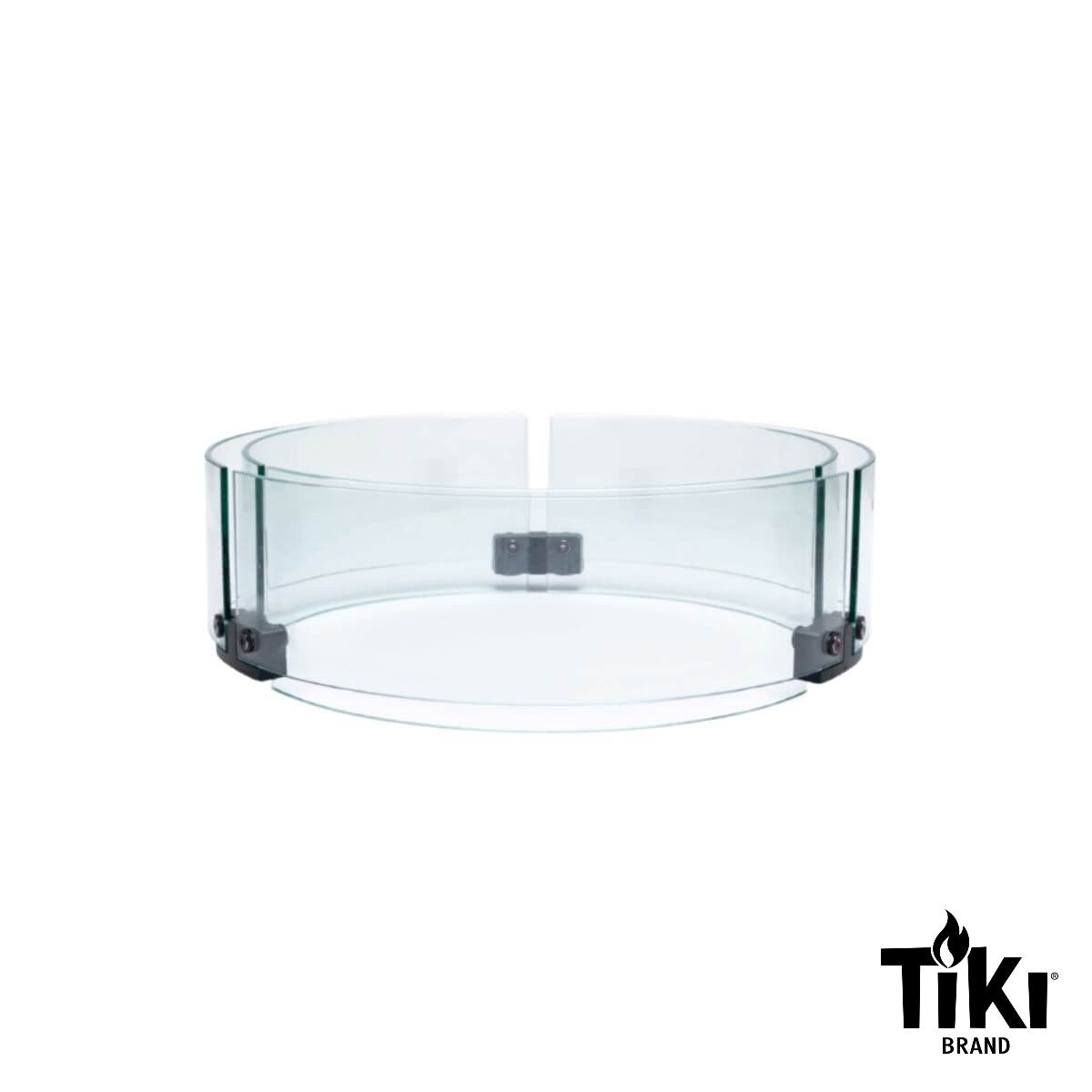 Clear round glass wind guard for TIKI fire pits, shown with metal brackets. TIKI Brand logo in lower right corner.
