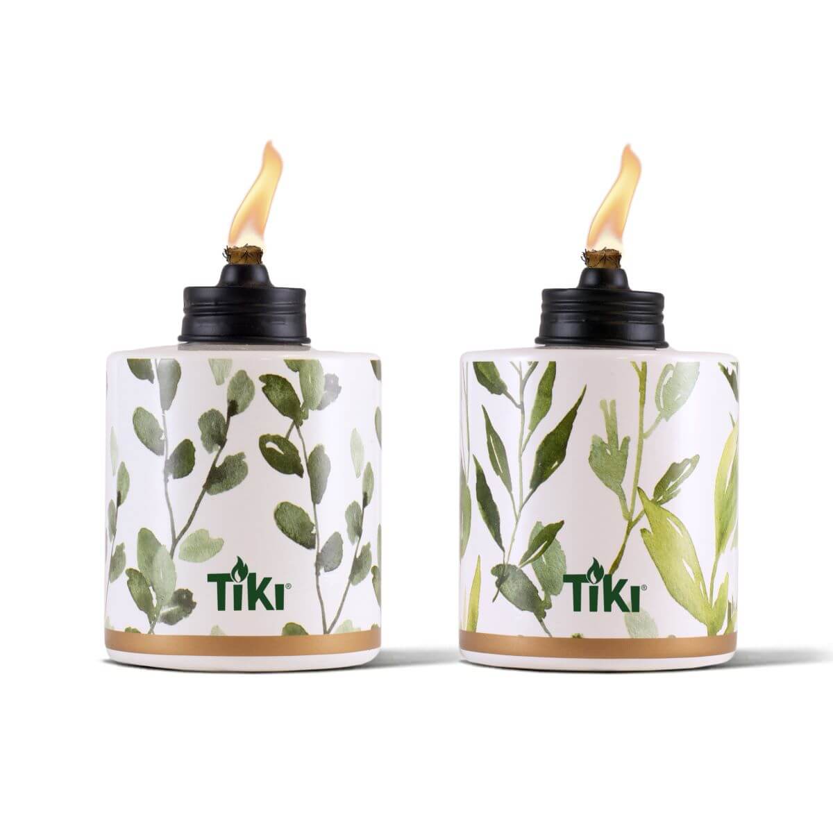 Two TIKI® brand tabletop torches with leafy green designs and visible flames, ideal for outdoor ambiance.