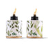 Two TIKI® brand tabletop torches with leafy green designs and visible flames, ideal for outdoor ambiance.