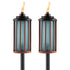 Pair of TIKI Brand outdoor torches with blue glass and bronze metal accents, each lit with a visible flame.