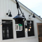 Close-up of TIKI Brand BiteFighter LED string light with mosquito repellent, hanging outdoors near a house.