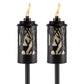 Pair of TIKI Brand torches with black deer and forest cutout design, each lit with a visible flame.