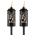 Pair of TIKI Brand torches with black deer and forest cutout design, each lit with a visible flame.