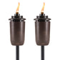 Pair of bronze TIKI torches with visible flames, designed for outdoor lighting and ambiance.