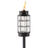 Black metal and glass TIKI® Brand torch with a visible flame, designed for outdoor lighting and ambiance.