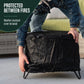 Weather-resistant black cover protects a small outdoor fire pit; easy to fit and remove, shown on a patio.