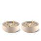 Two beige TIKI® brand outdoor candles, each with three lit wicks in round bowls, designed for patio use.