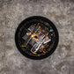 Black charcoal grill with burning coals on a gray surface.