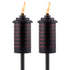 Two black TIKI Brand outdoor torches with modern slatted design, each lit with a visible flame.