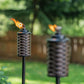 Brown woven torch with flame, outdoor use.