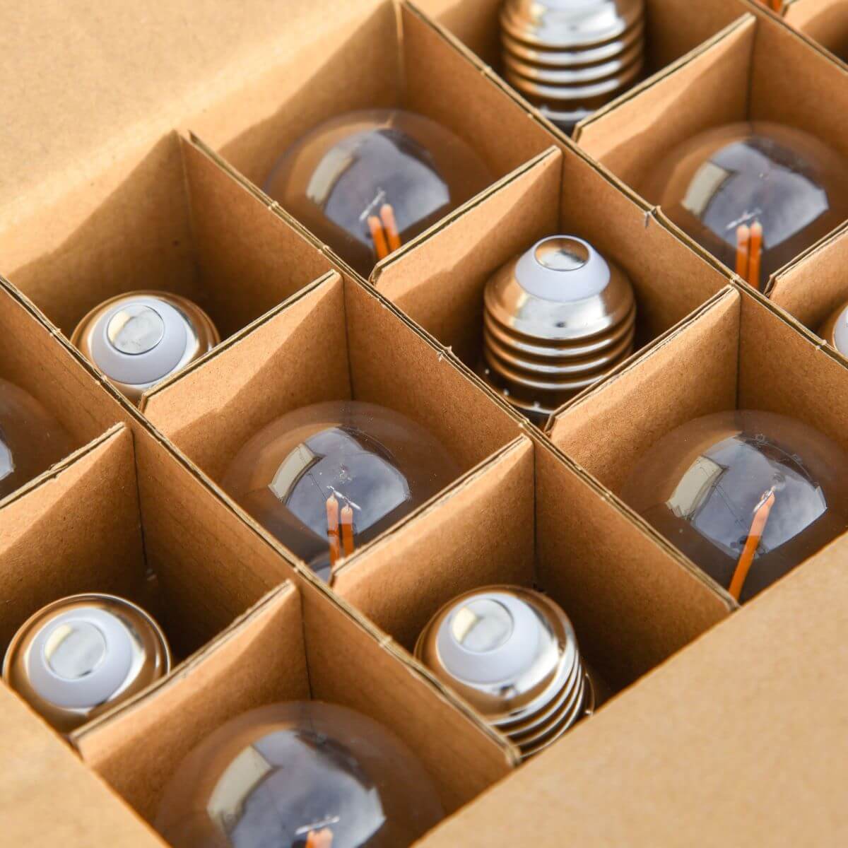 Box of replacement TIKI Brand torch fuel canisters, neatly organized in cardboard dividers for safe storage and transport.