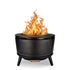 Black metal outdoor fire pit with perforated sides, three legs, and visible flames rising from the top.