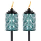 Pair of teal glass TIKI torches with diamond pattern, black tops, and visible flames, designed for outdoor ambiance.