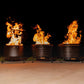 Three TIKI® fire pits burning brightly outdoors at night, showcasing safe, stylish backyard fire features.