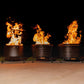 Three black fire pits with vibrant flames, set outdoors on a patio.