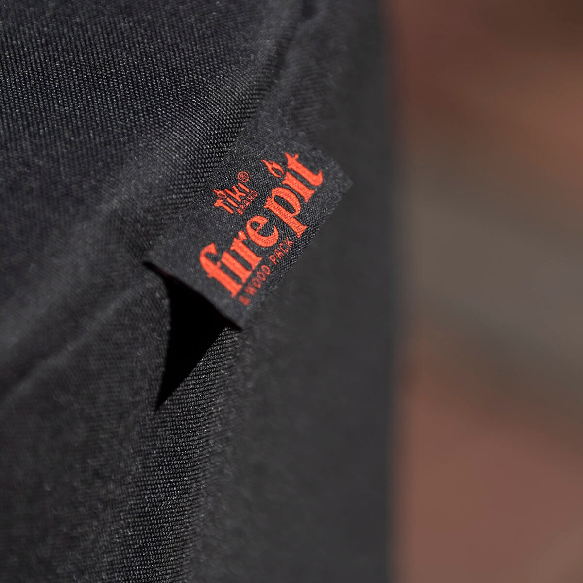 TIKI Brand Patio Smokeless Fire Pit Replacement Cover, close-up of fabric tag with fire pit logo