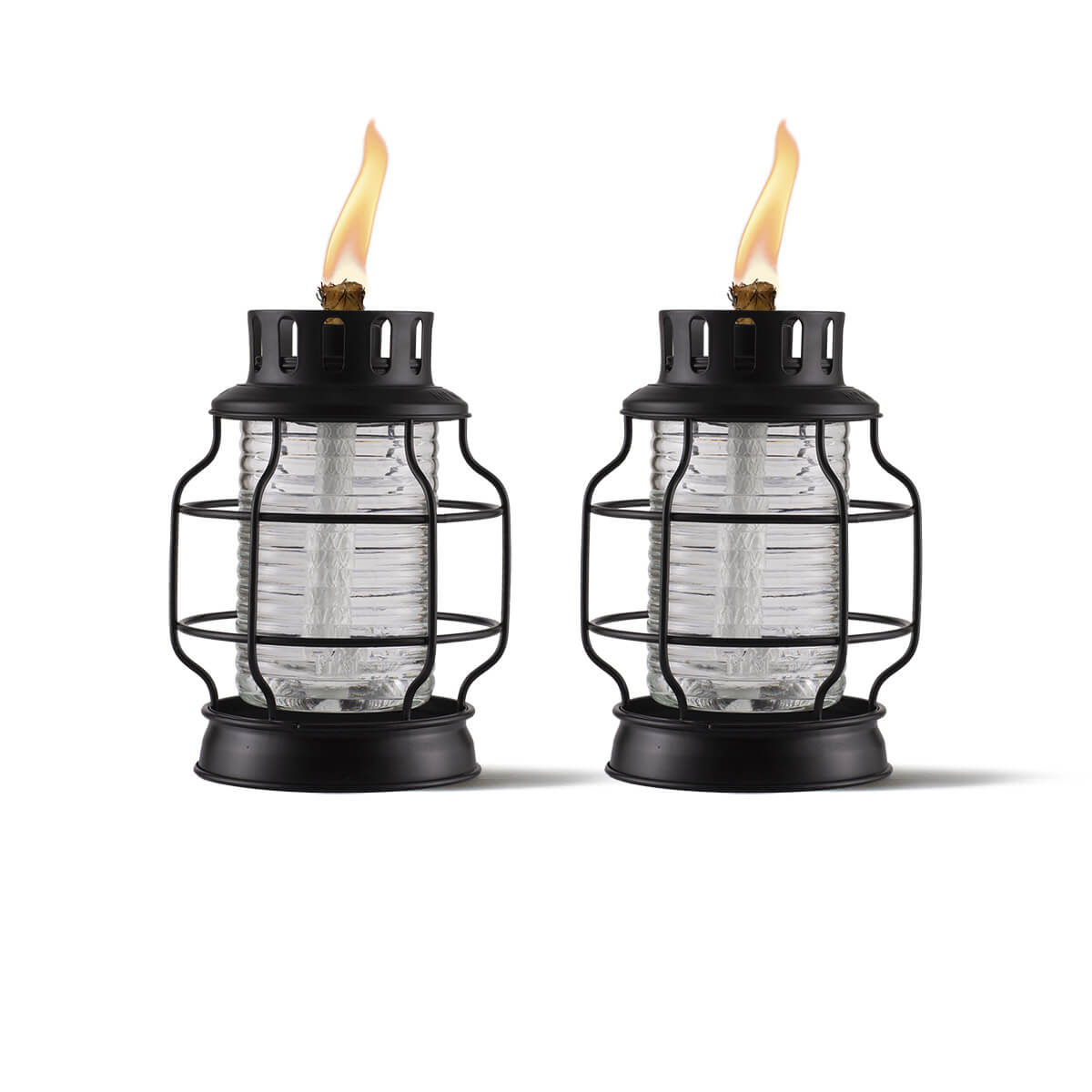 Two black metal and glass TIKI® lanterns with visible flames, designed for outdoor ambiance and mosquito repellent.