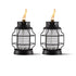 Two black metal and glass TIKI® lanterns with visible flames, designed for outdoor ambiance and mosquito repellent.