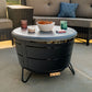 TIKI Brand Reunion Tabletop Cover Gray on fire pit, used as table with snacks and drinks outdoors