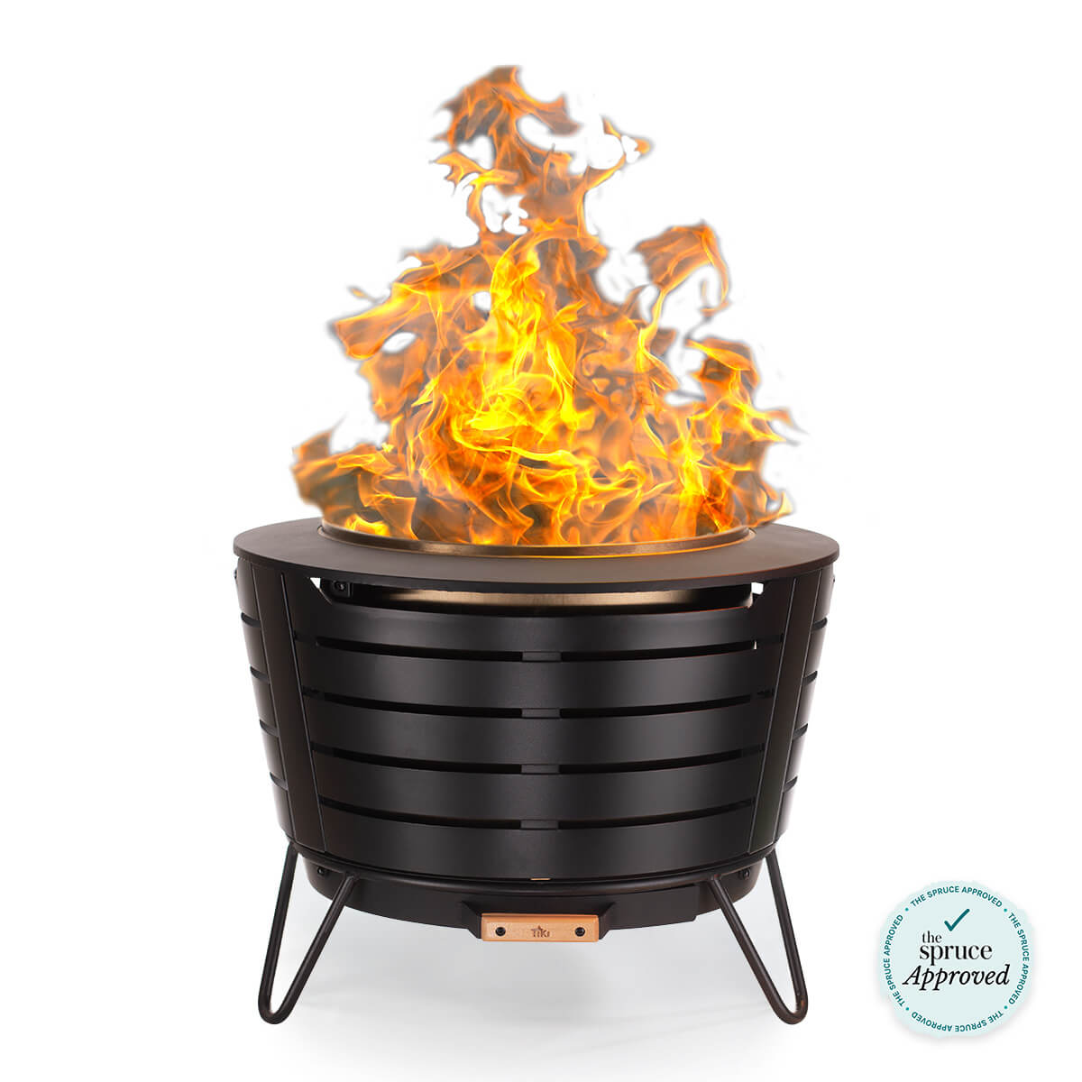 Round black metal fire pit with slatted sides, raised on three legs, showing bright flames.