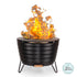 Round black metal fire pit with slatted sides, raised on three legs, showing bright flames.